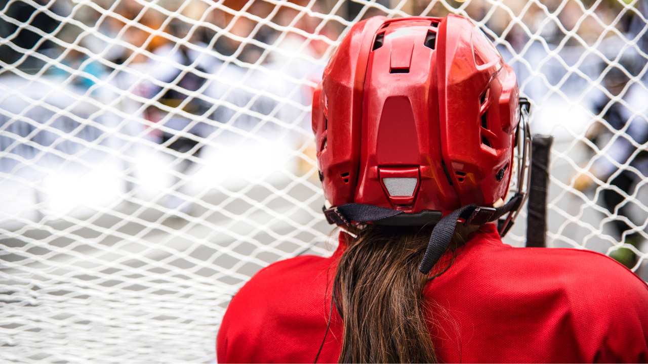 A hockey player wearing a red helmet and red jersey
