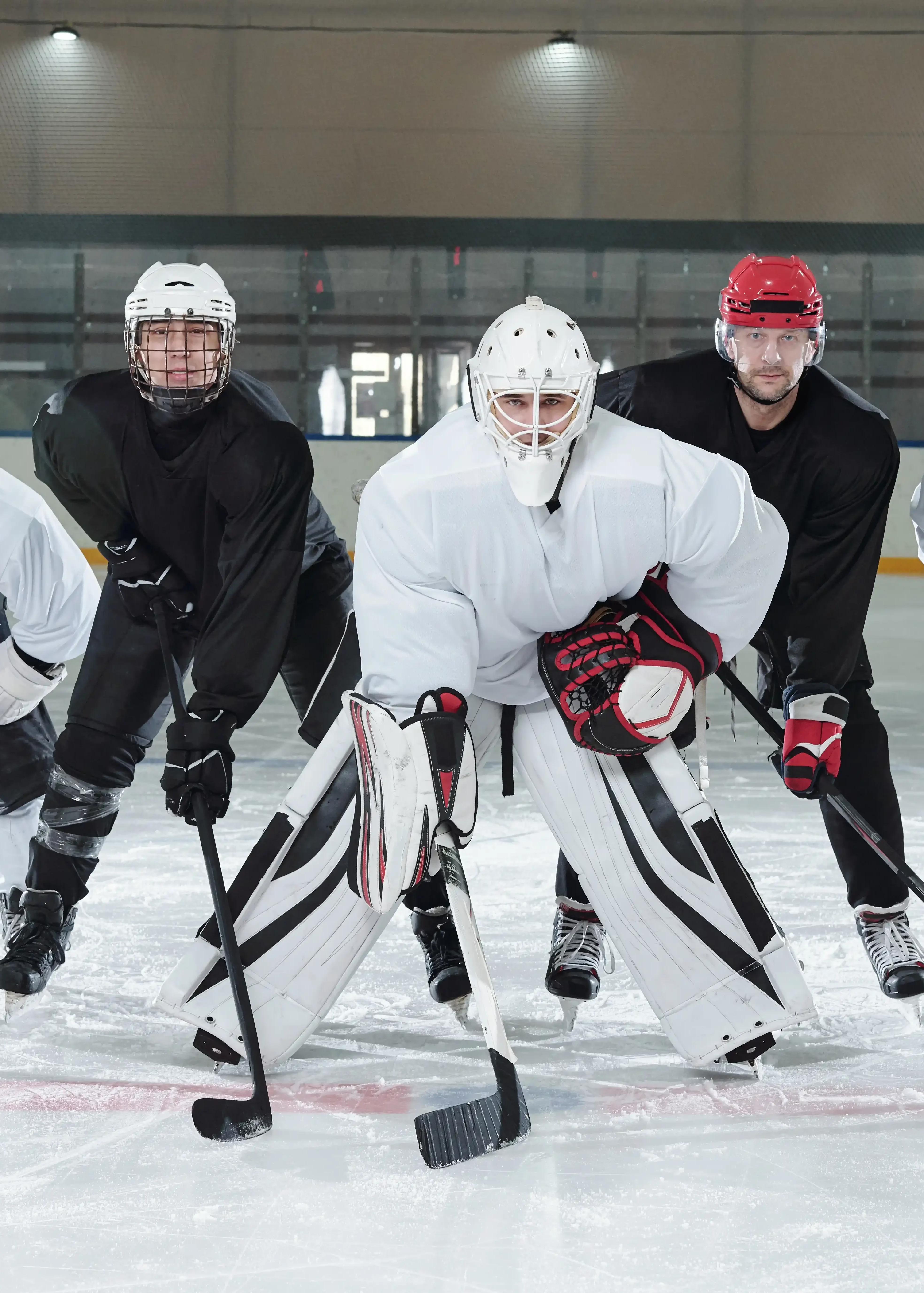 professional-hockey-players-gloves-skates-helmets-bending-forwards-while-standing-ice-rink-training-before-play-stadium