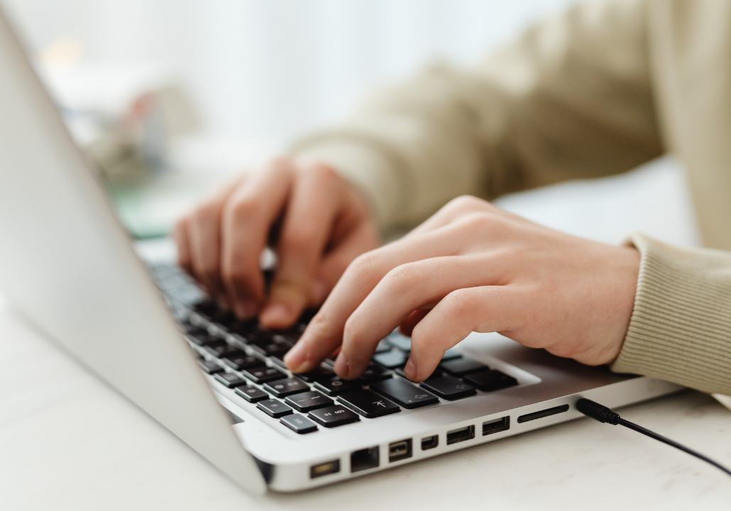 A person typing on the computer
